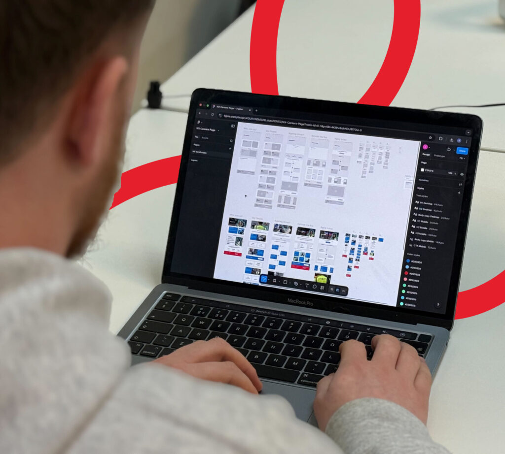 A designer creating a seamless candidate experience journey flow on his laptop